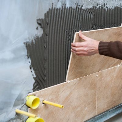 Applying new tiles on bathroom wall