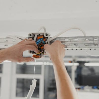 Electrical Expertise in Action, Junction Wiring Installation with Skilled Hands in Close-up view