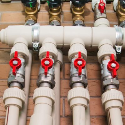 Copper valves, stainless ball valves, detector of water and plastic pipes of central heating system and water pipes in apartment during under renovation, remodeling and construction